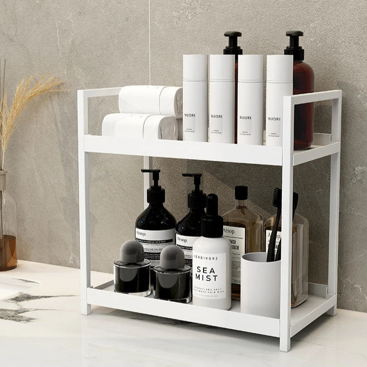 White metal shelf with skincare products against a gray wall.