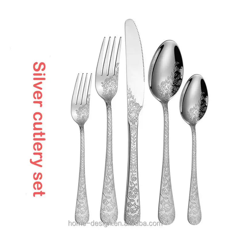 Silver cutlery set with floral patterns on a white background
