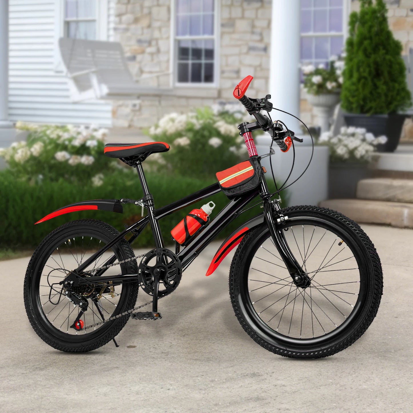 Black and red children's bicycle on a patio with a house in the background