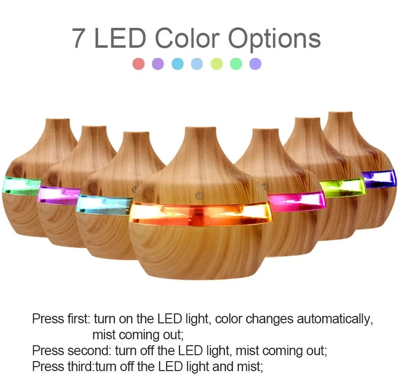 Wooden diffuser with LED lights showing 7 color options on a white background.