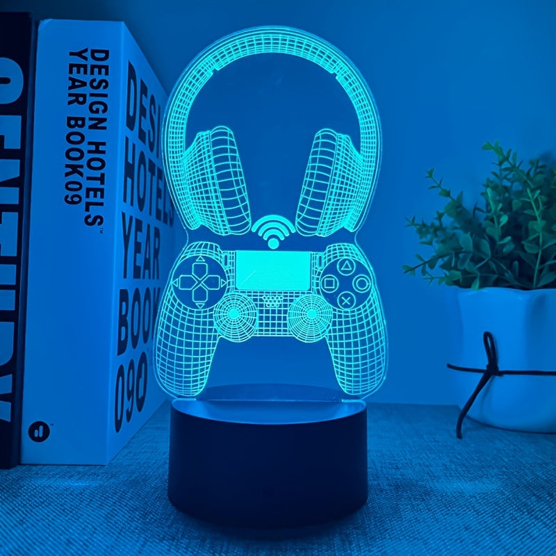 3D LED lamp shaped like a gaming controller and headphones on a table with a book and plant in the background.
