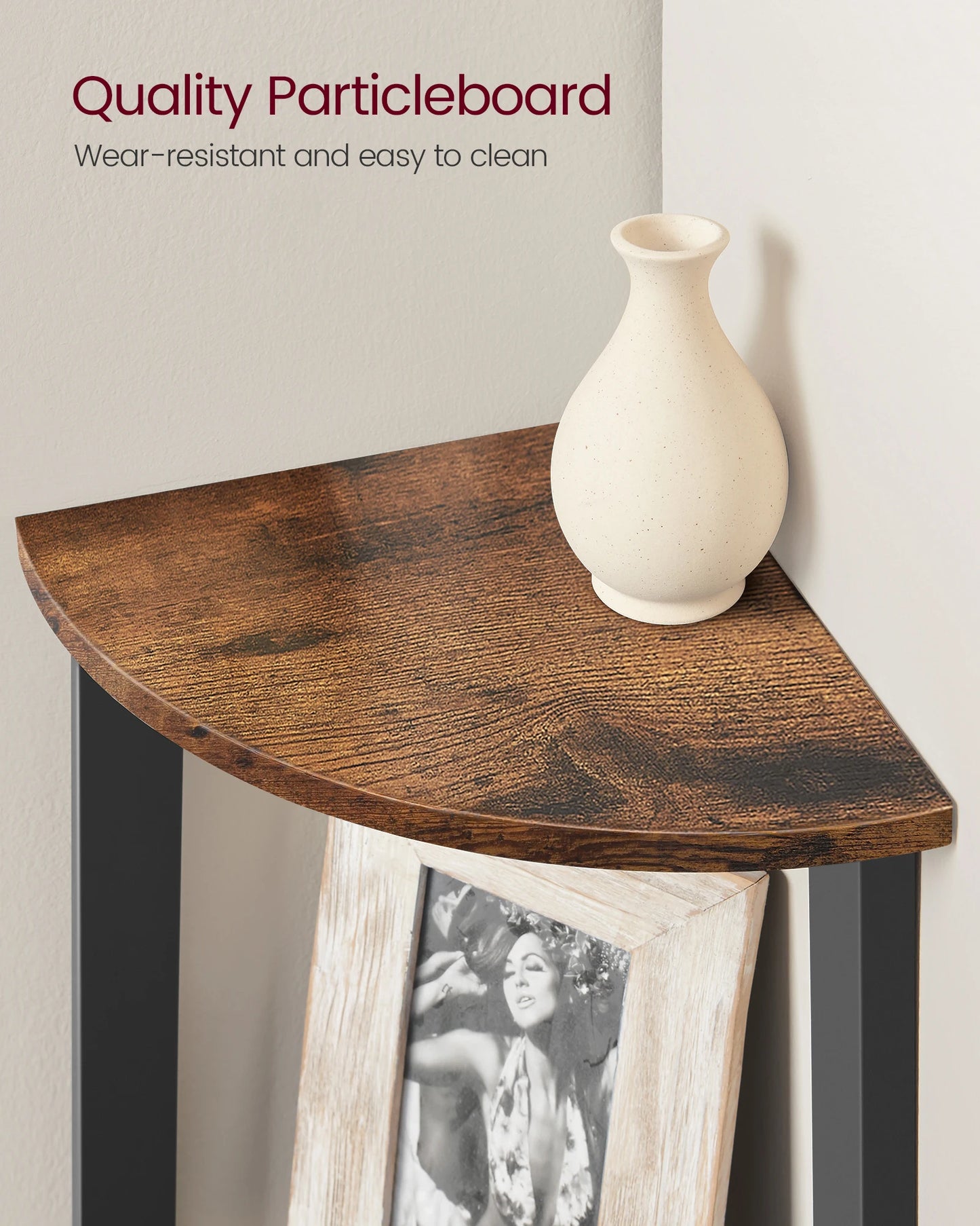 Wooden corner table with a vase and photo frame against a plain wall.