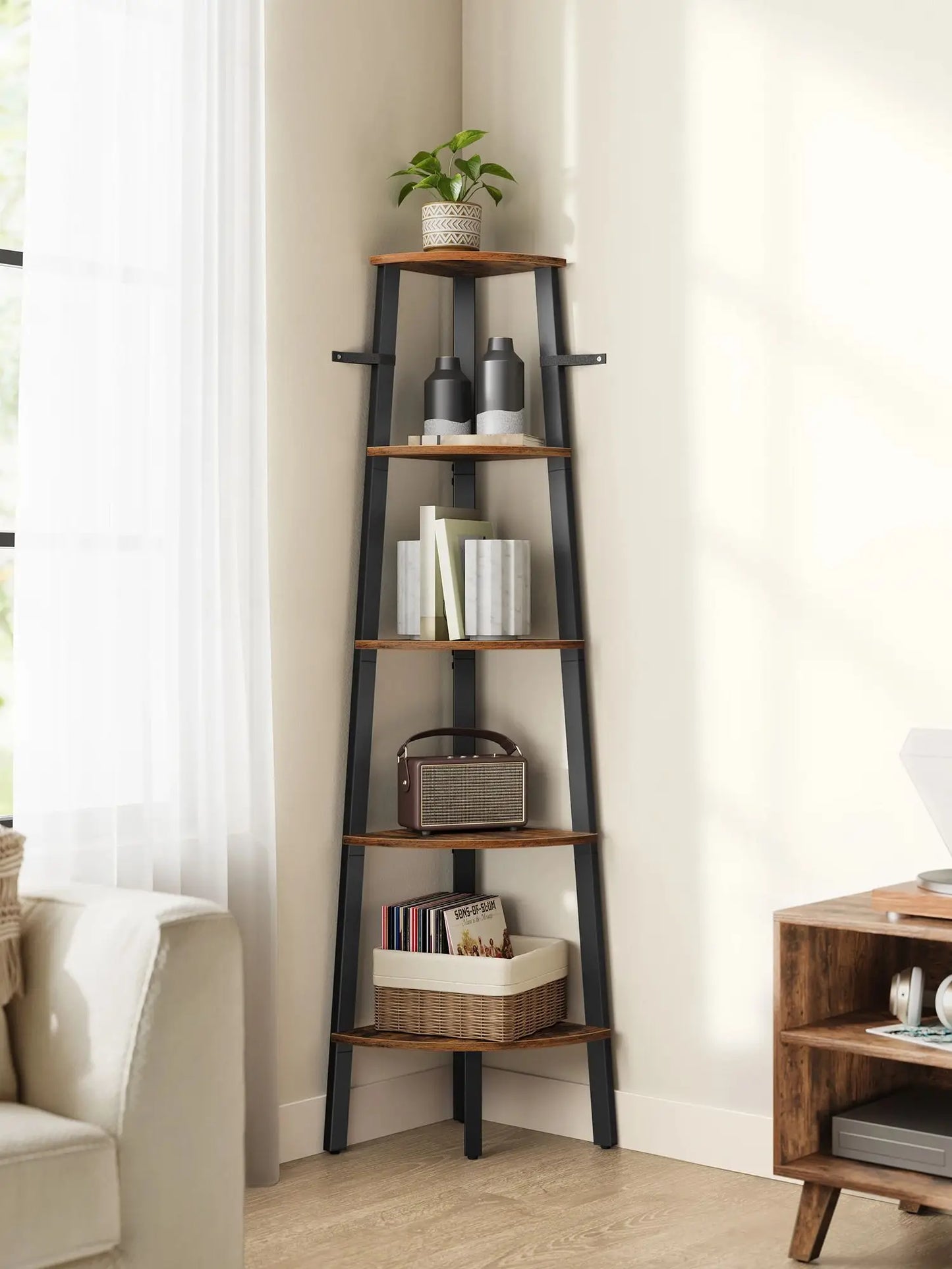 Tall corner ladder shelf with decorative items against a white wall.