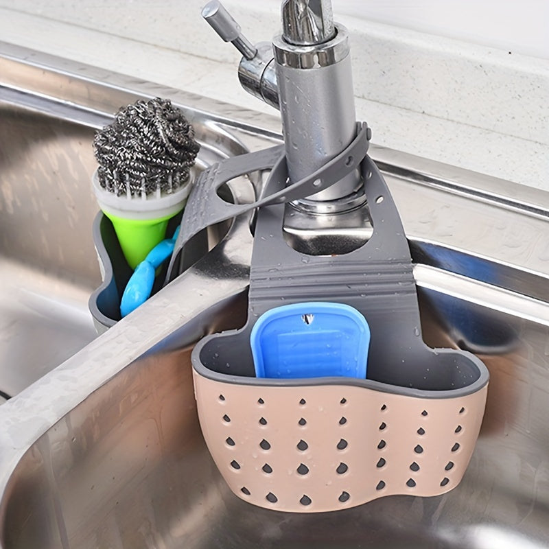 Sink caddy with sponge holder and cleaning brush in a kitchen sink.