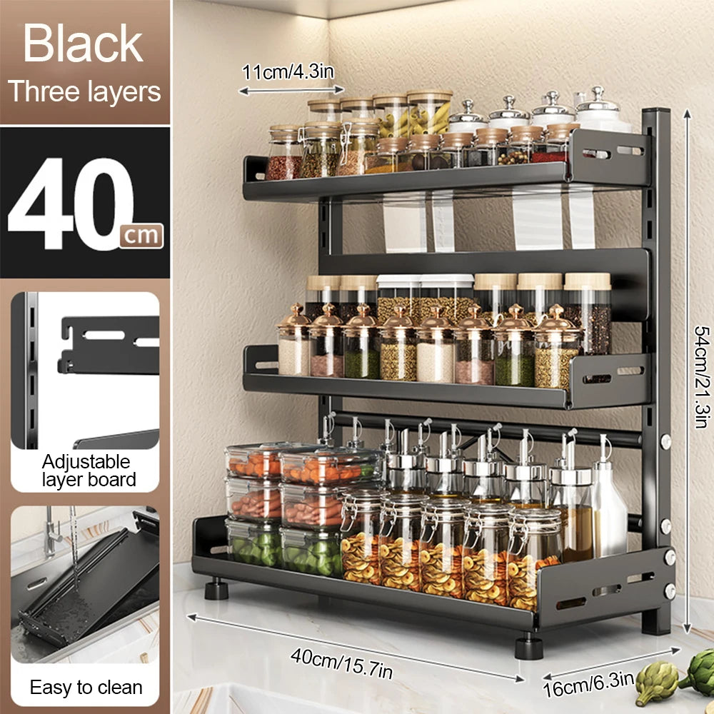 Black three-layer spice rack with jars of spices on a neutral background