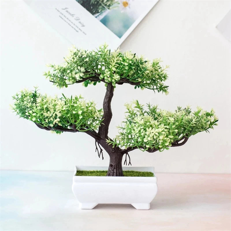 Artificial bonsai tree in a white pot on a light background