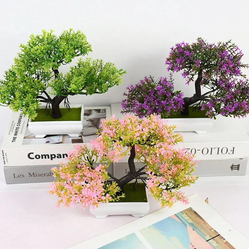 Artificial plants in pots on top of books with a white background