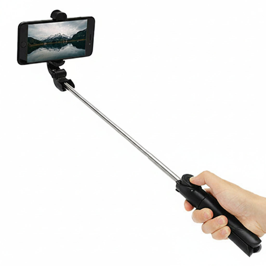 Hand holding a black selfie stick with a phone attached on a white background