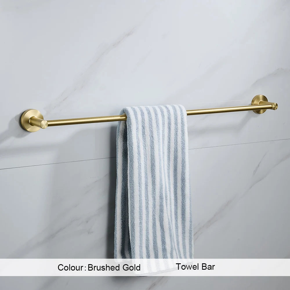 Gold towel bar with a striped towel on a tiled wall