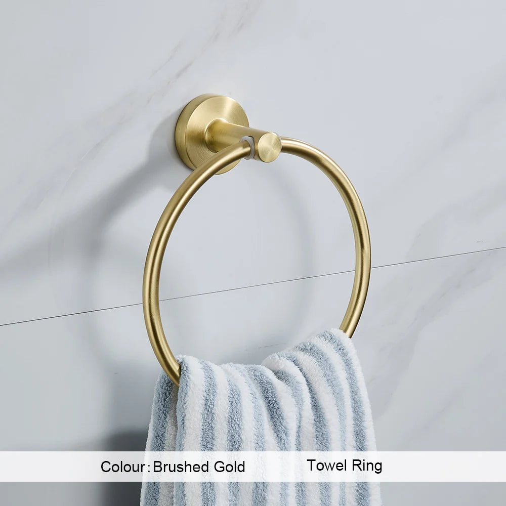 Gold towel ring with a striped towel on a tiled wall background