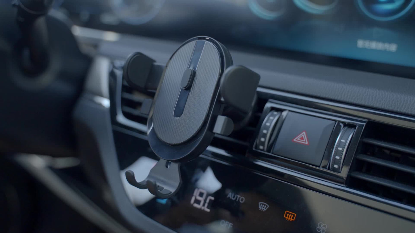 Car dashboard with a wireless charging device mounted on it.
