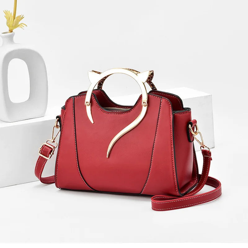 Red handbag with gold accents on a white background