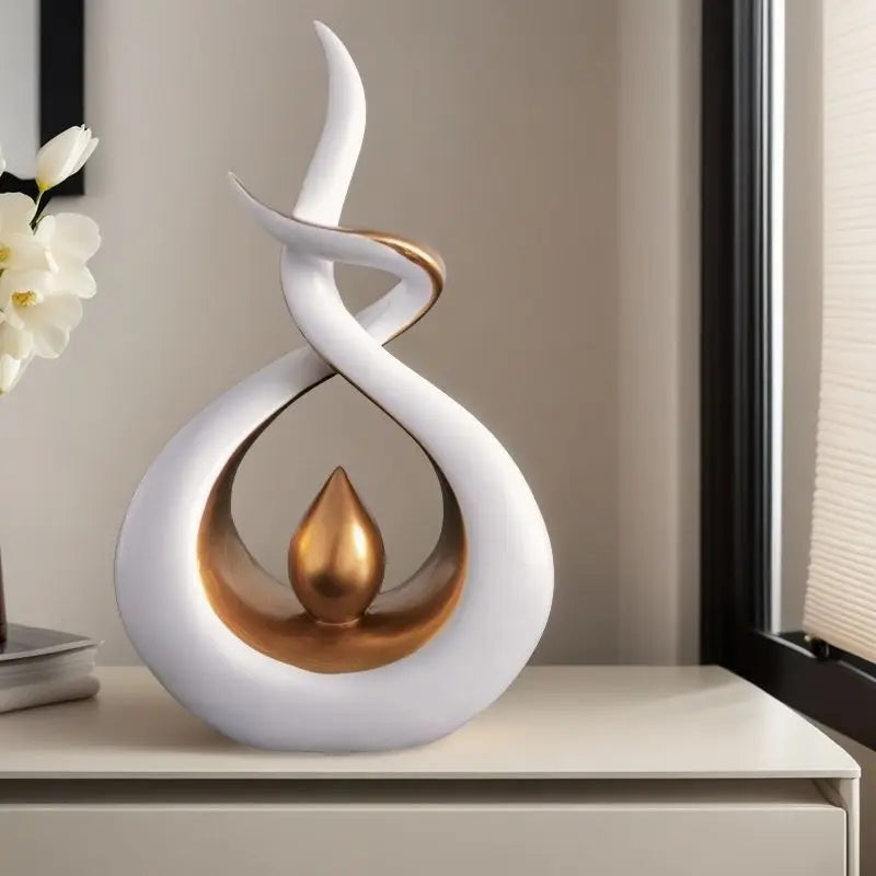 Decorative sculpture with white and gold design on a shelf