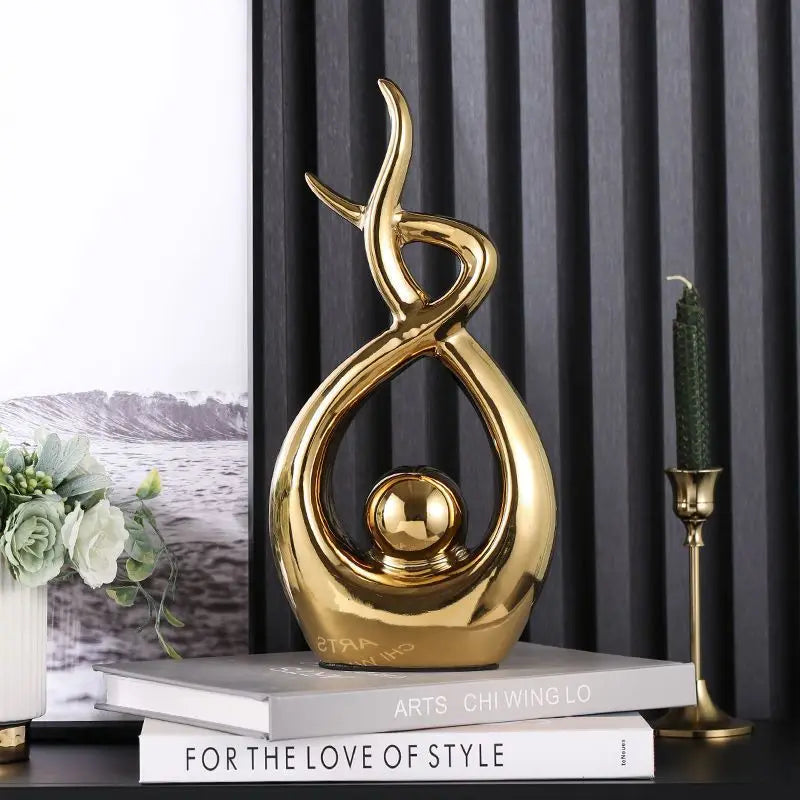 Gold decorative sculpture on books with a blurred landscape in the background