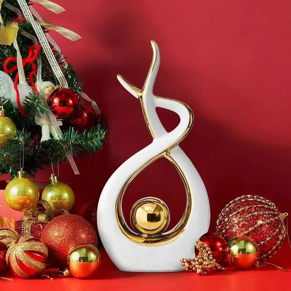 Decorative sculpture with gold and white design on a red background with Christmas ornaments.