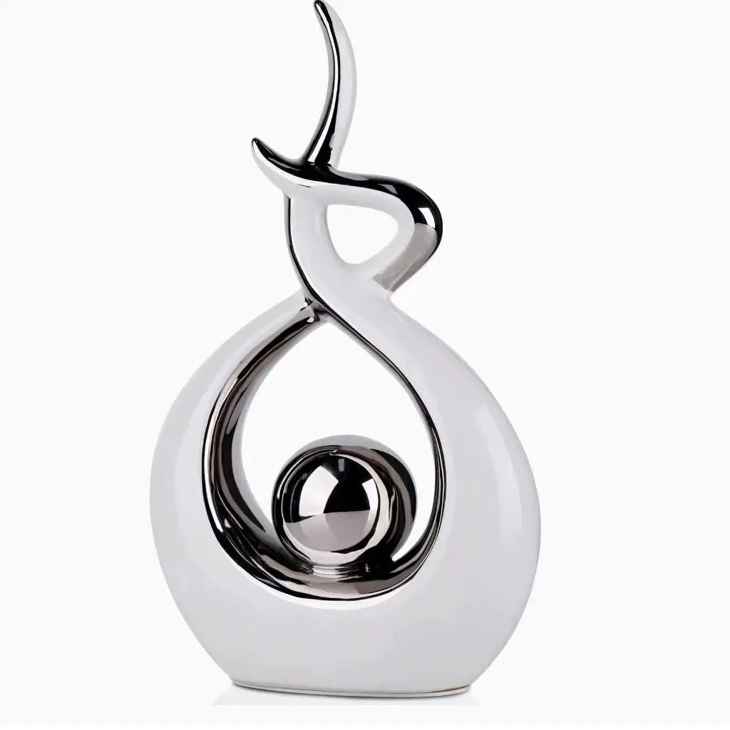 Silver decorative object with a unique design on a white background
