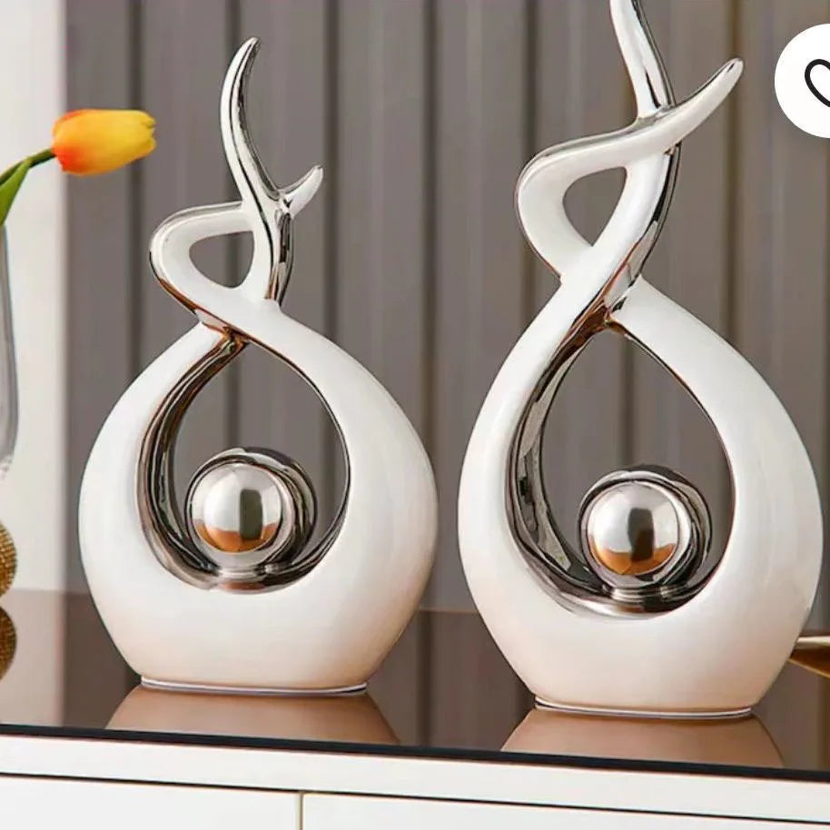 Two decorative vases with a modern design on a reflective surface.