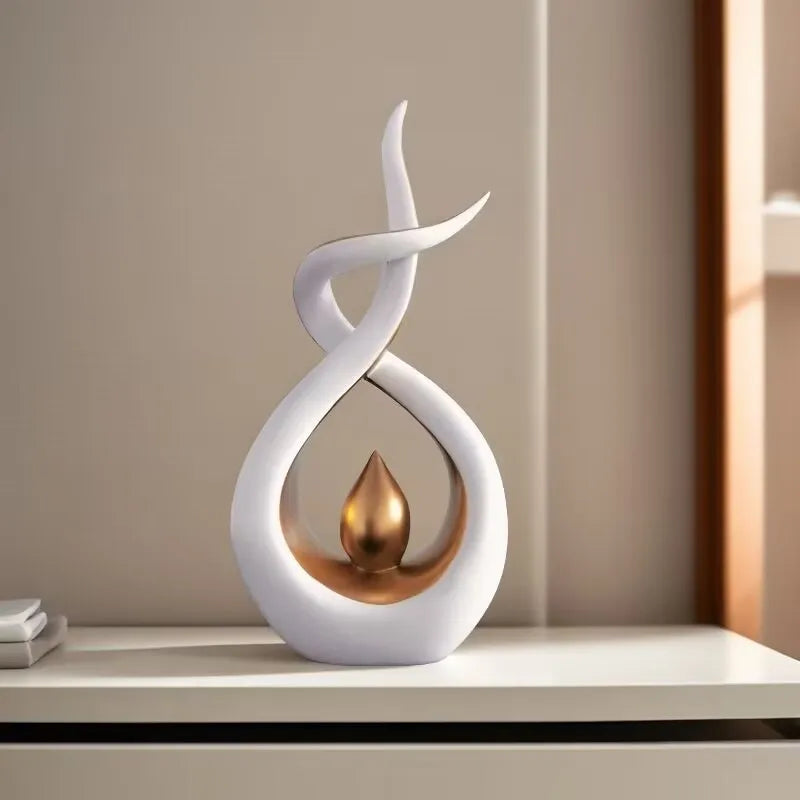 Decorative sculpture with white and bronze design on a shelf