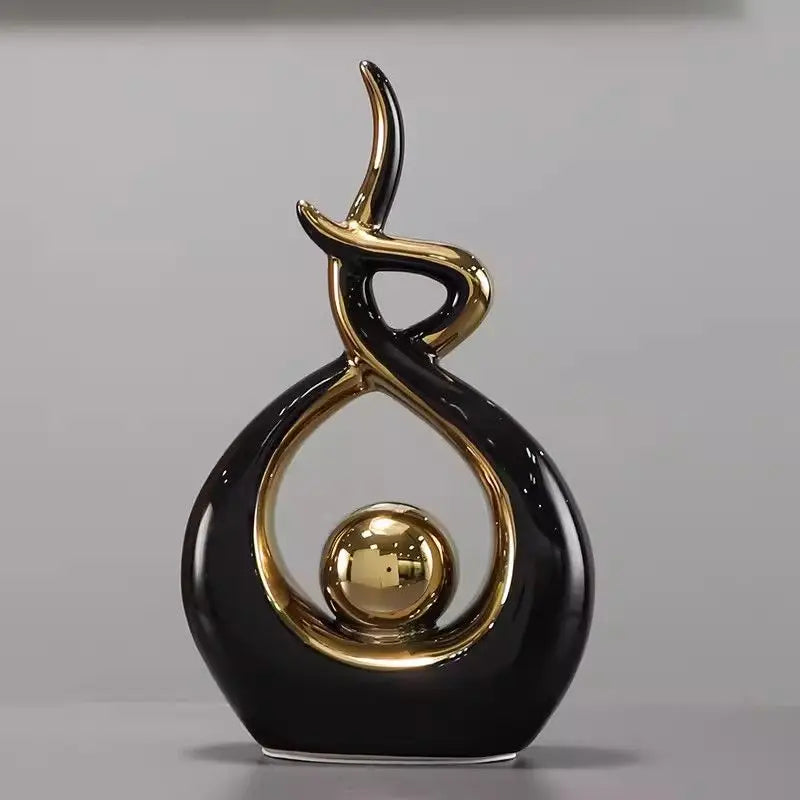 Decorative object with black and gold design on a gray background