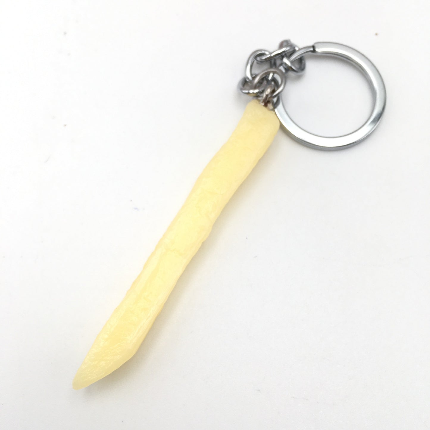 Chip French Fry Keychain with a yellow handle and silver ring on a white background