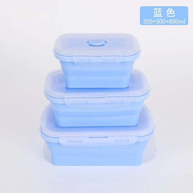 Set of three blue silicone containers with lids on a light gray background