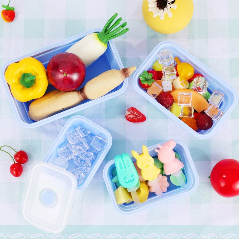 Colorful toy food items in transparent containers on a light blue background