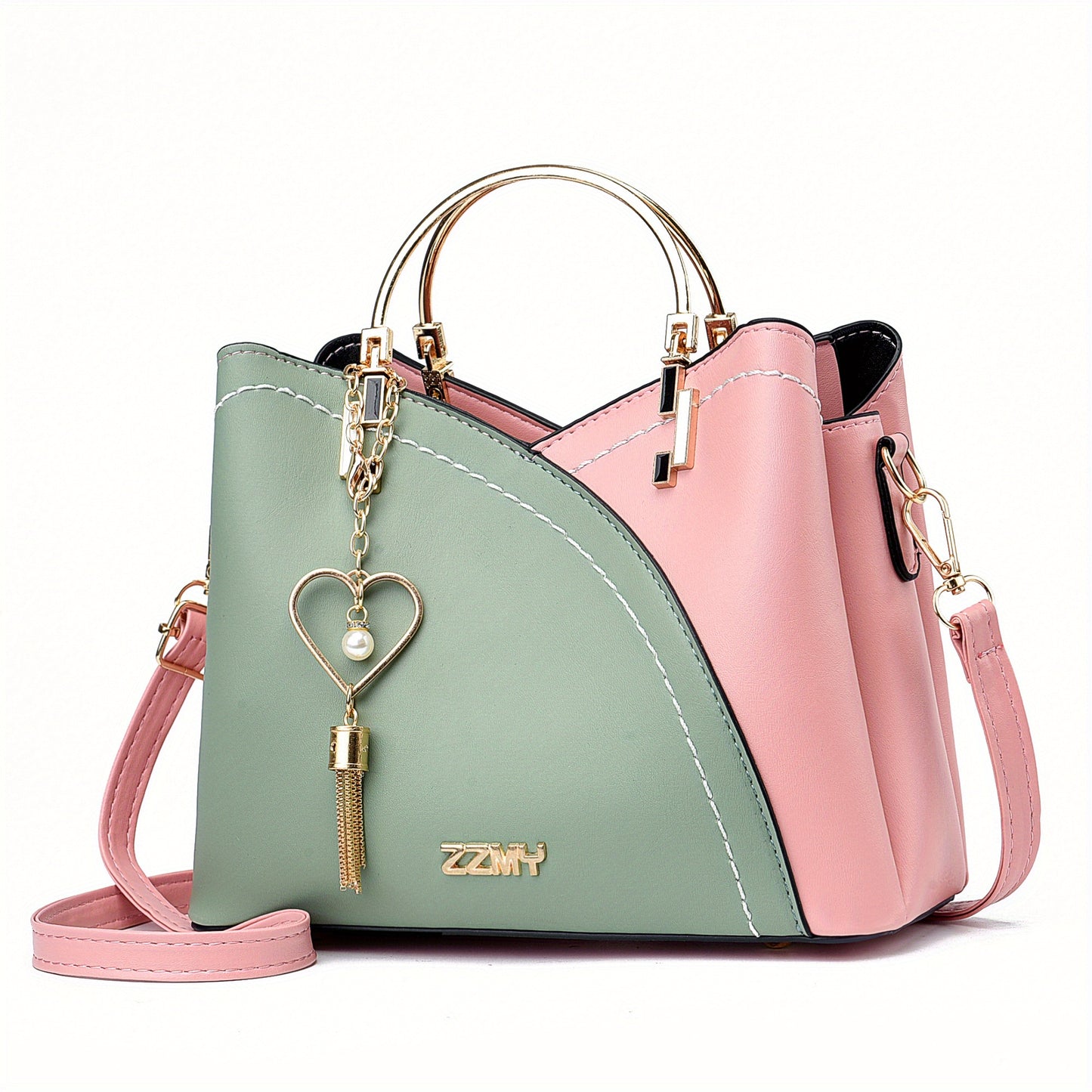 Two-tone pink and green handbag with a heart-shaped keychain on a white background