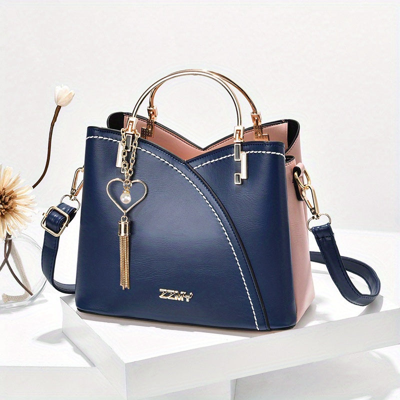 Blue handbag with gold accents on a white surface
