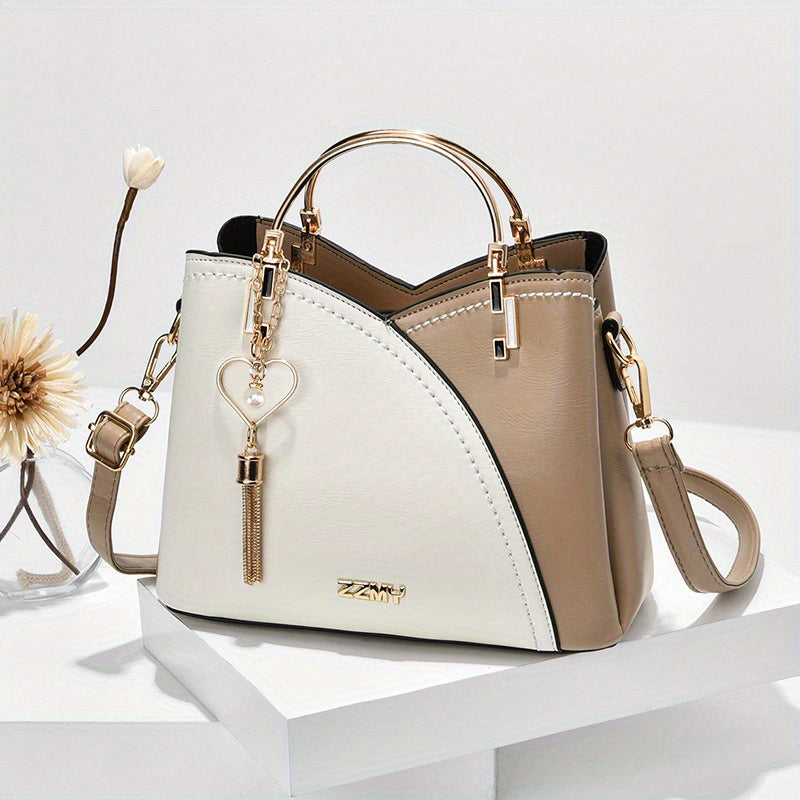 Two-tone handbag with beige and white design on a white background