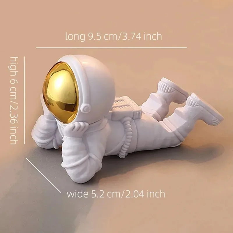 White astronaut figurine with gold helmet on a beige background, showing measurements.