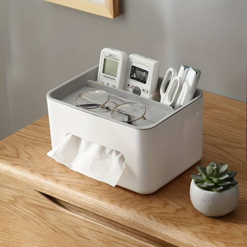White desk organizer with electronic devices, glasses, scissors, and tissues on a wooden surface.