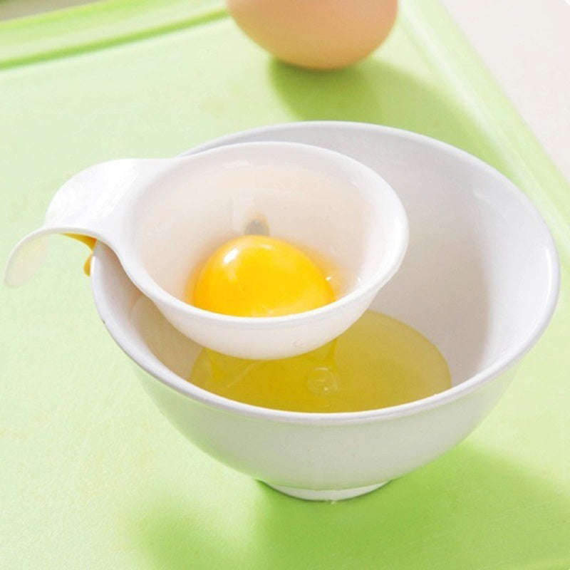 Egg yolk in a white bowl with a green background