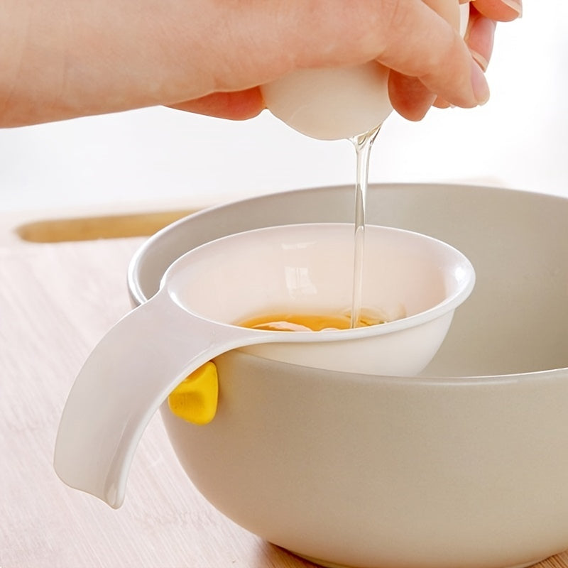 Egg separator being used to separate egg yolks into a bowl.