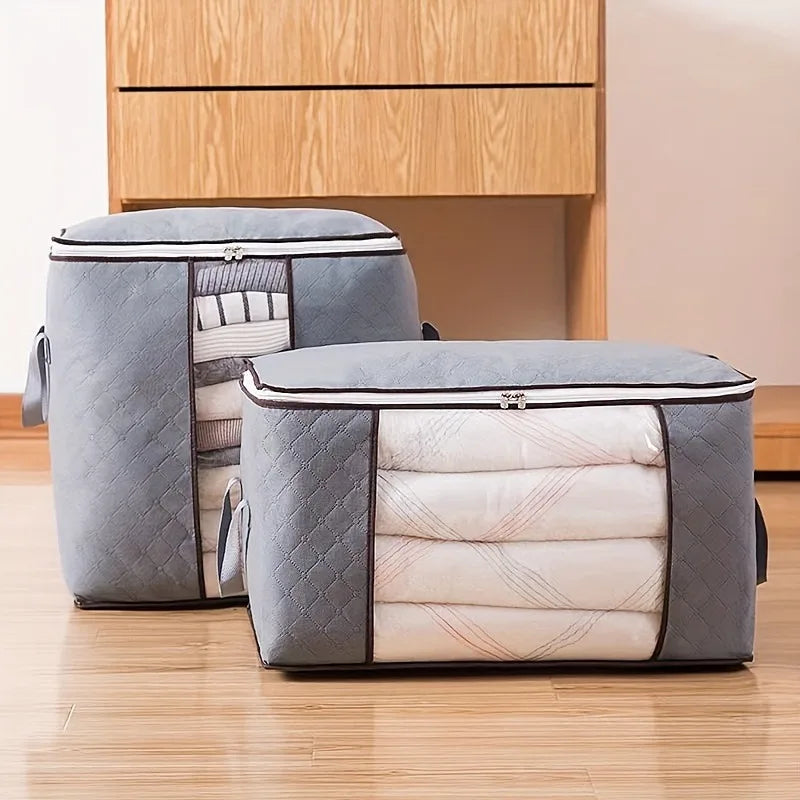 Two gray storage bags with quilted texture on a wooden floor.