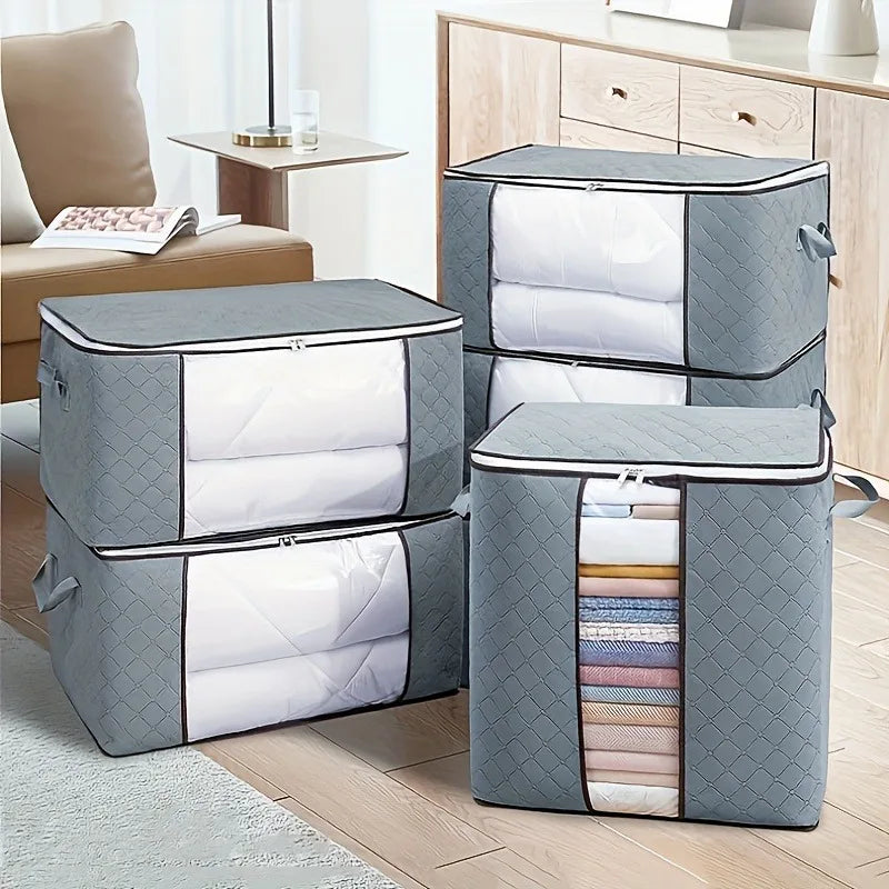 Set of gray storage boxes with quilted design on a wooden floor.