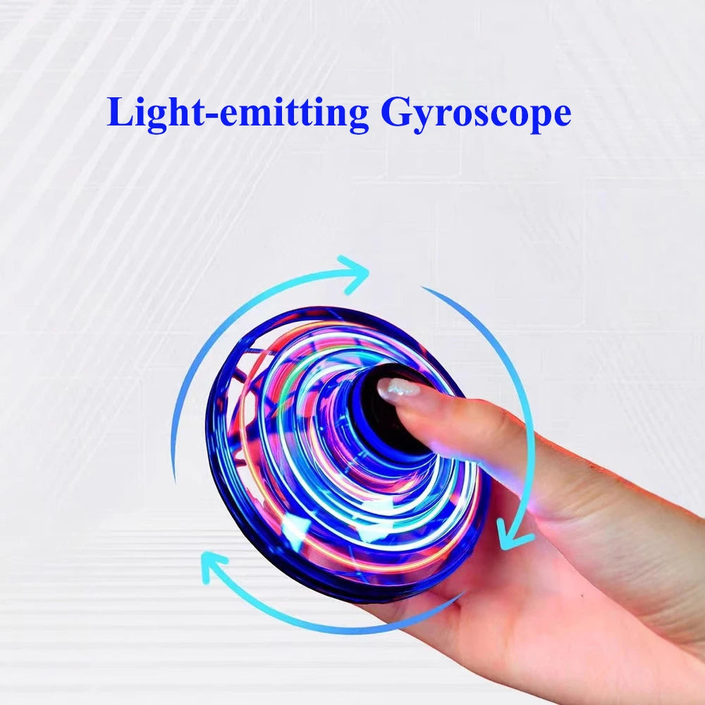 Light-emitting gyroscope with colorful design held by a hand on a white background