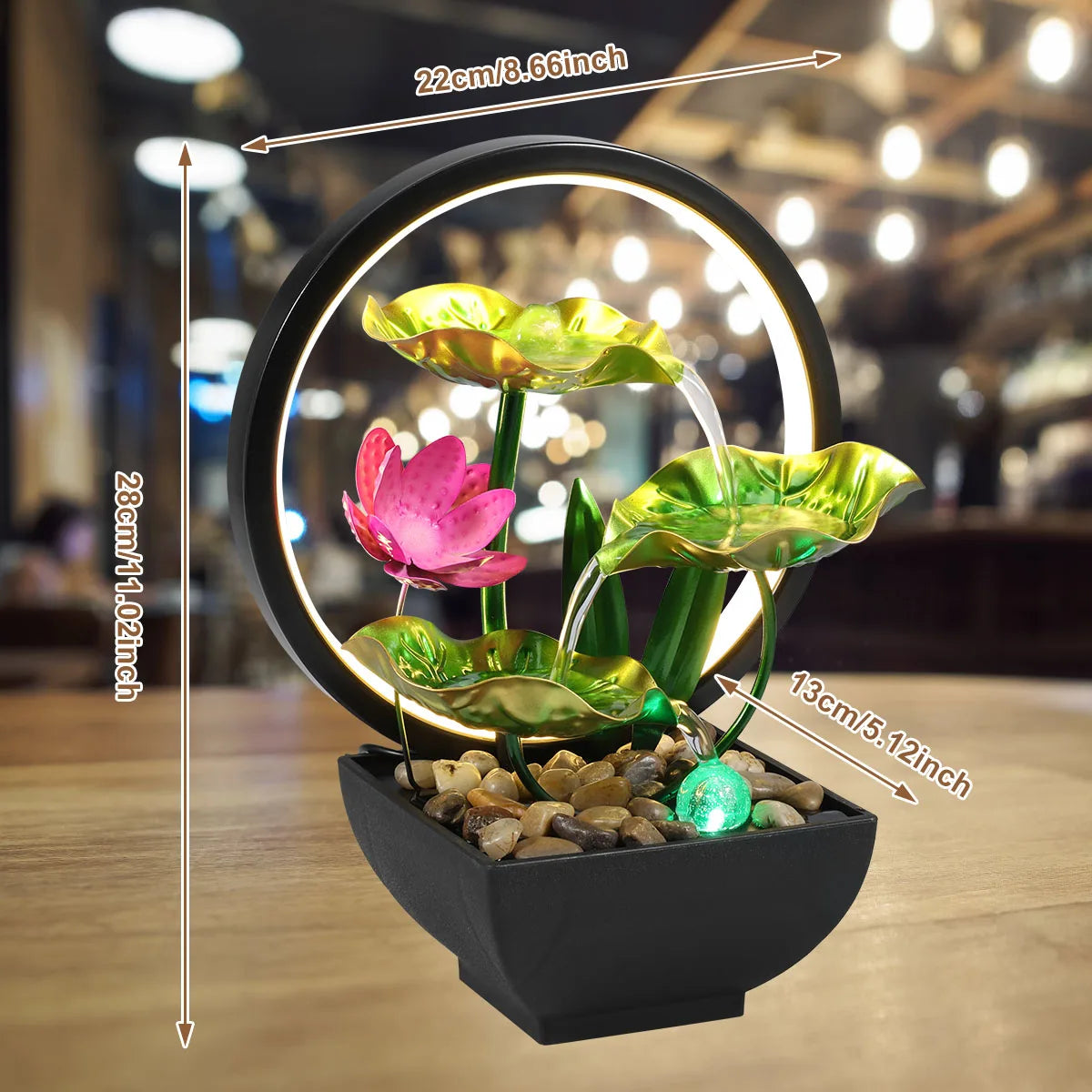 Decorative water fountain with lotus flowers and measurements on a wooden surface.