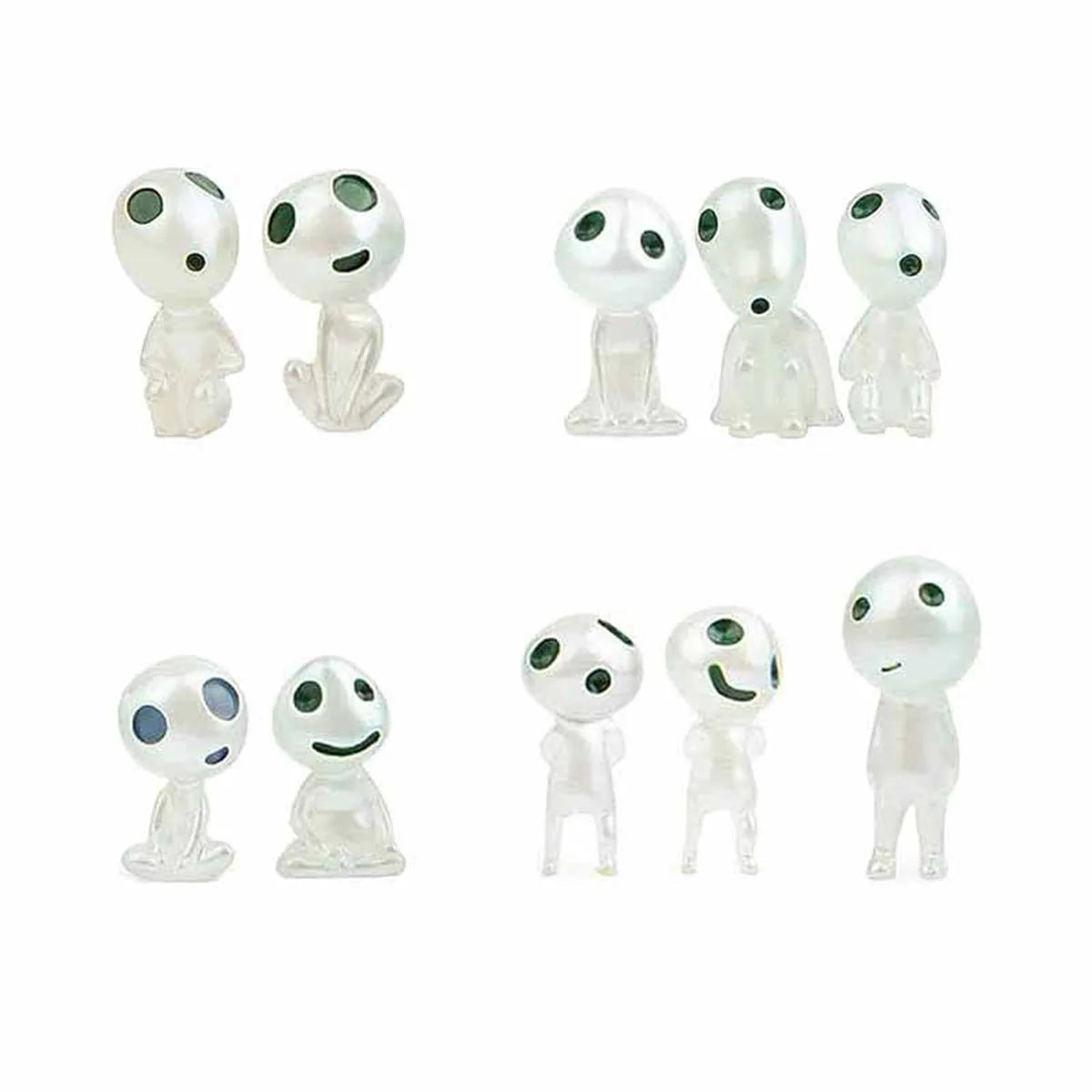 Set of small white figures with black eyes and green accents on a white background