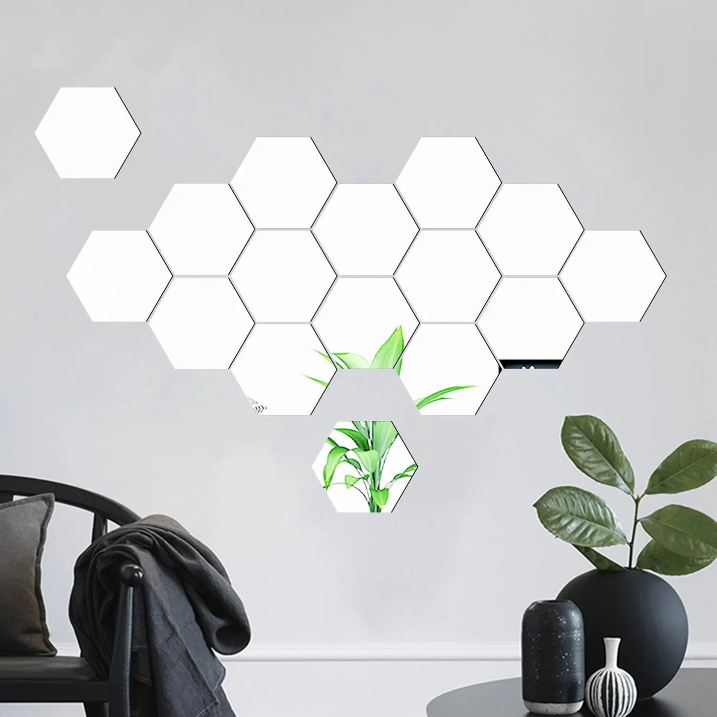 Hexagonal light panels on a wall with a plant and decorative items below.