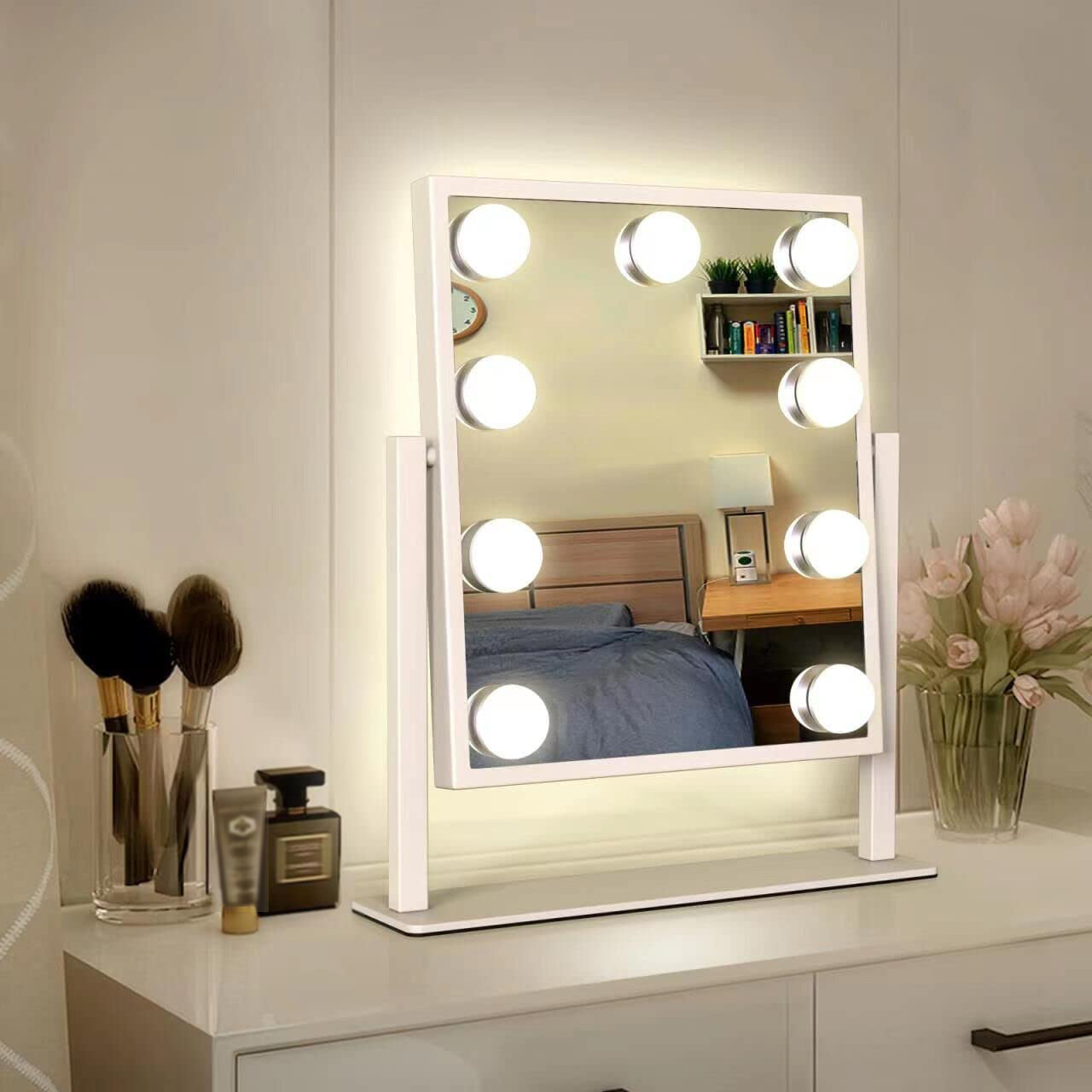 Makeup mirror with lights on a vanity table in a bedroom setting
