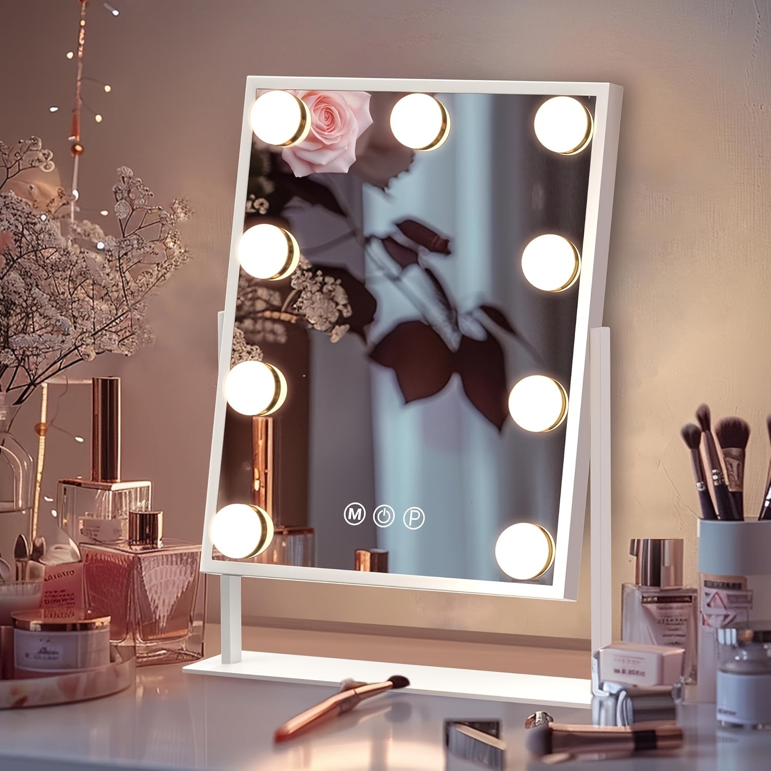 Makeup mirror with lights on a vanity table with beauty products.
