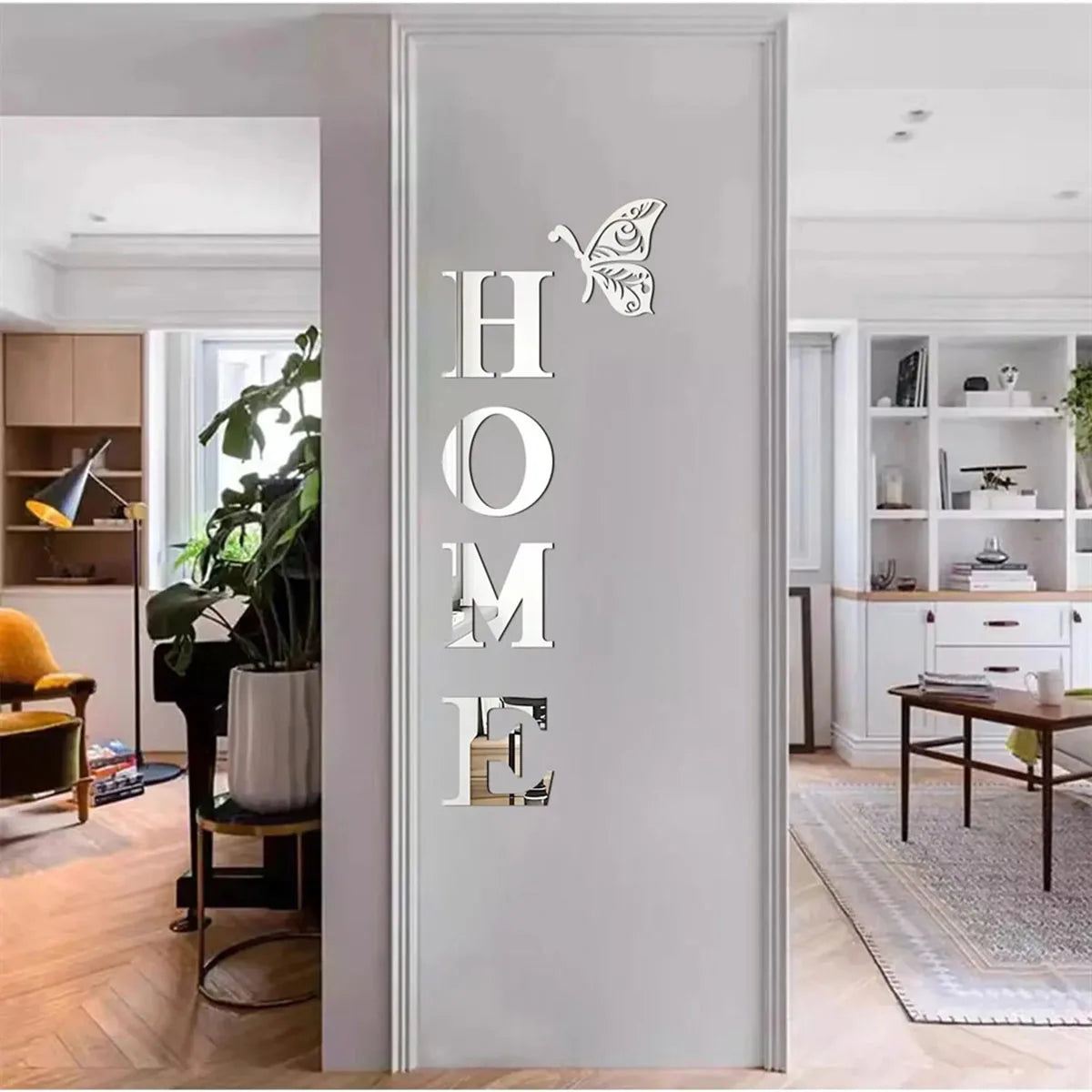 Decorative mirror with 'HOME' and butterfly design on a wall in a modern living room.