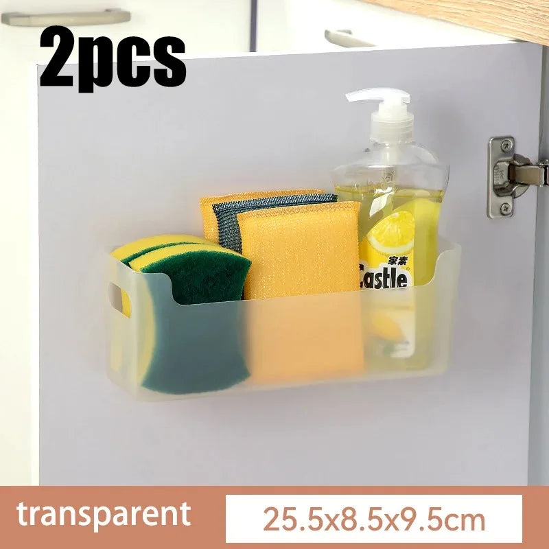 Transparent wall-mounted organizer holding cleaning supplies on a white wall.