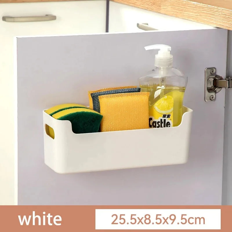 White cabinet organizer with sponges and soap inside, attached to a kitchen cabinet.