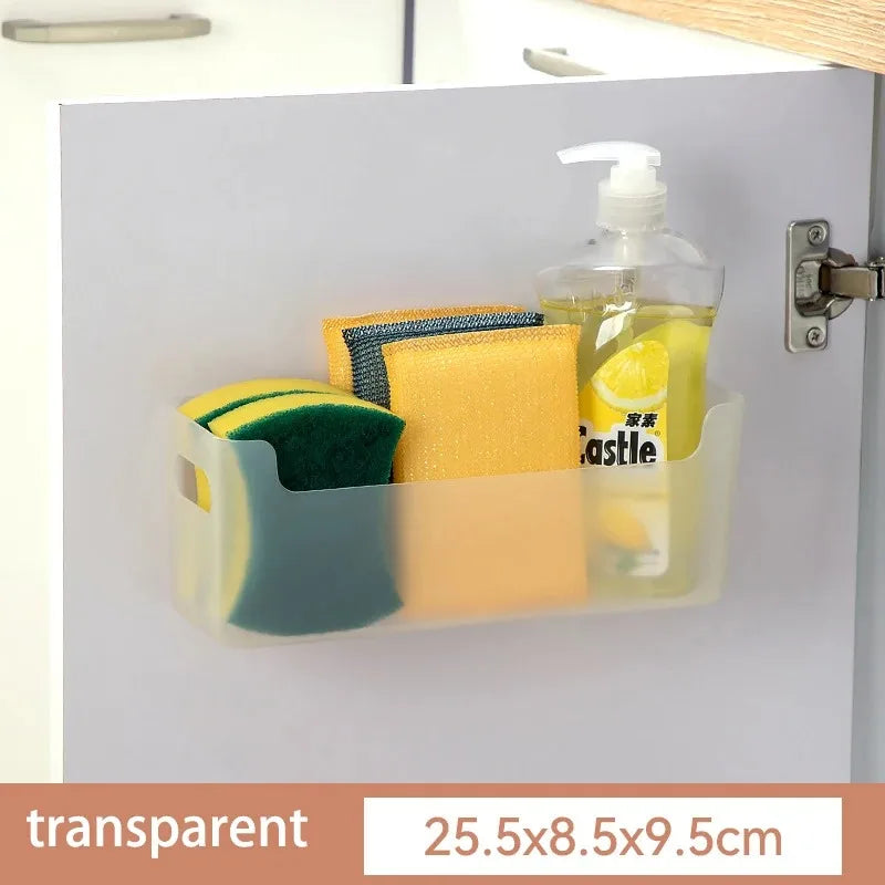 Cabinet organizer with sponges, a cloth, and a bottle of soap on a white cabinet door.
