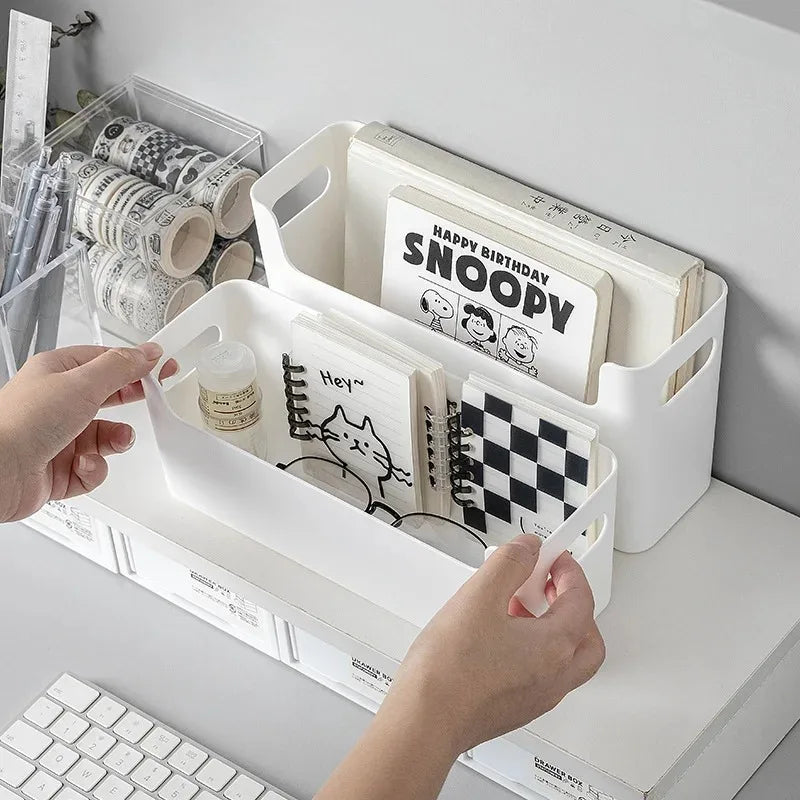 White storage bins with stationery items on a desk
