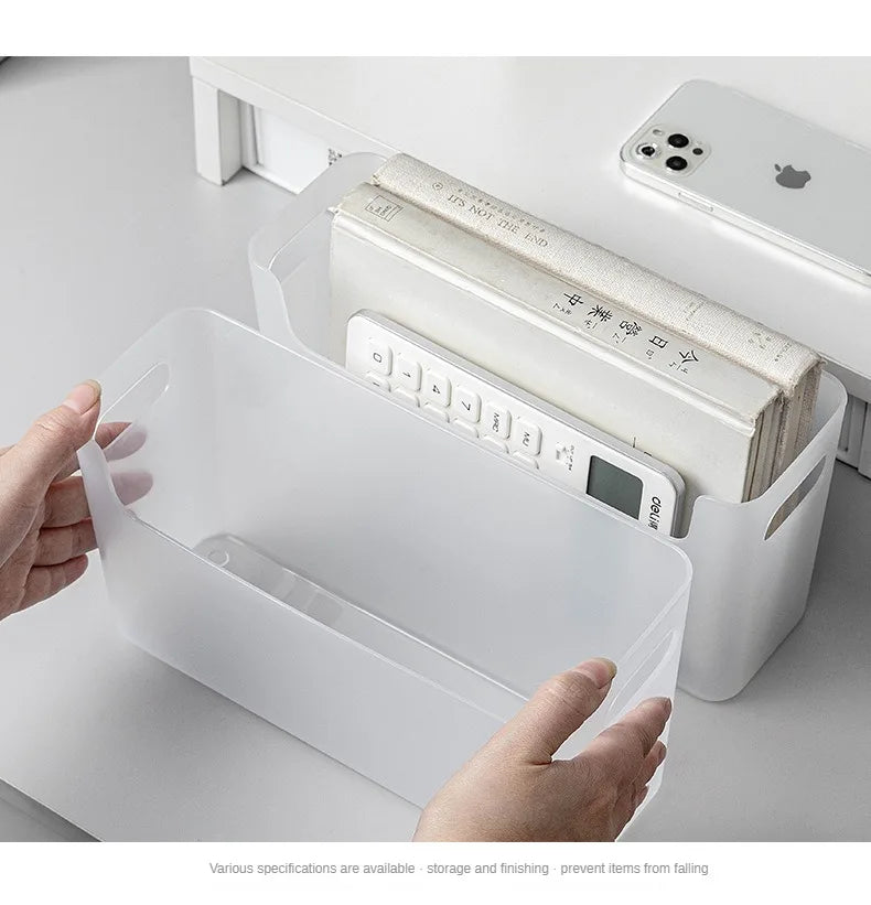White storage box with a digital scale inside, held by a hand on a white surface.