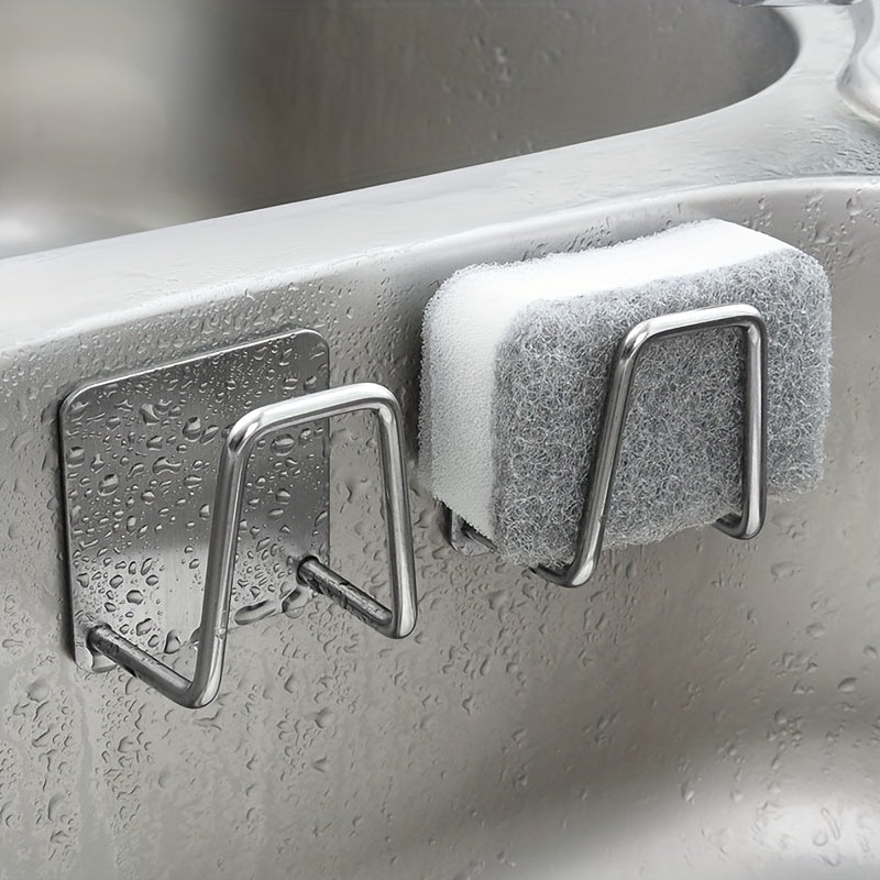 Metal hooks with a sponge on a kitchen sink