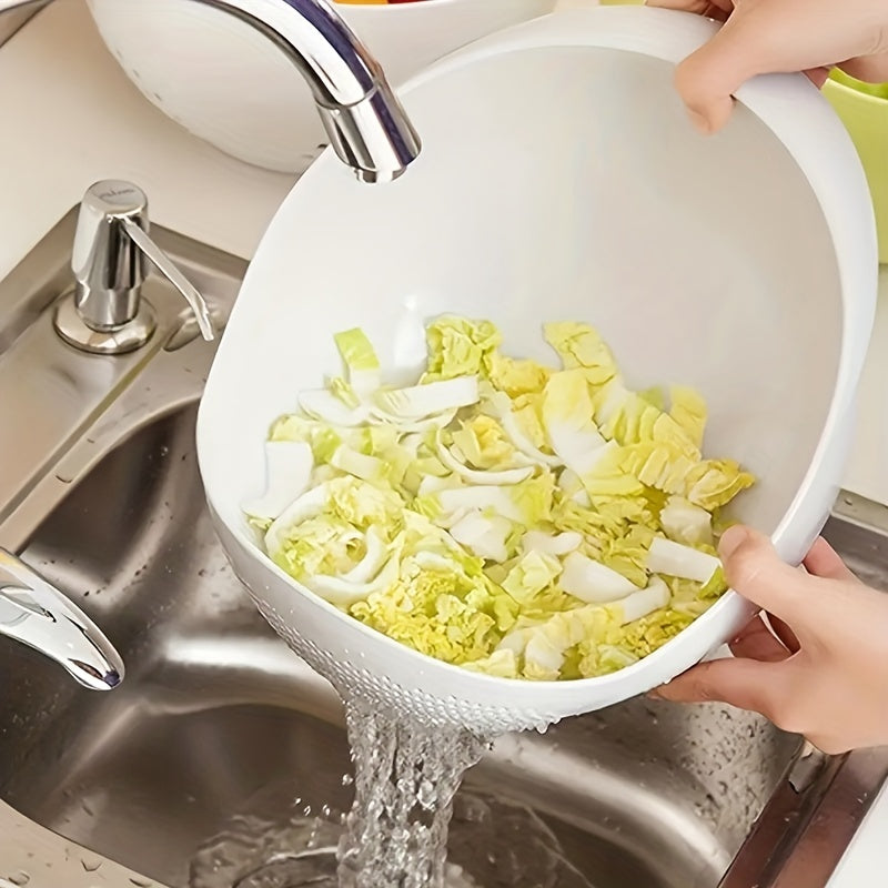 Person washing vegetables in a white colander under running water in a kitchen sink.