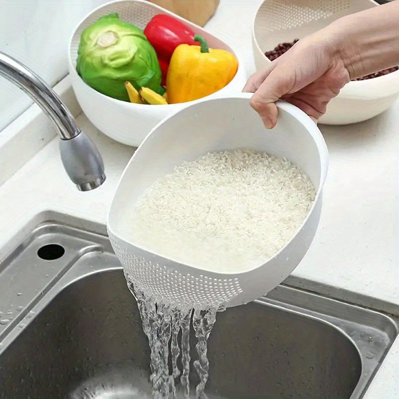 Person rinsing rice in a white colander over a sink with colorful vegetables in the background.